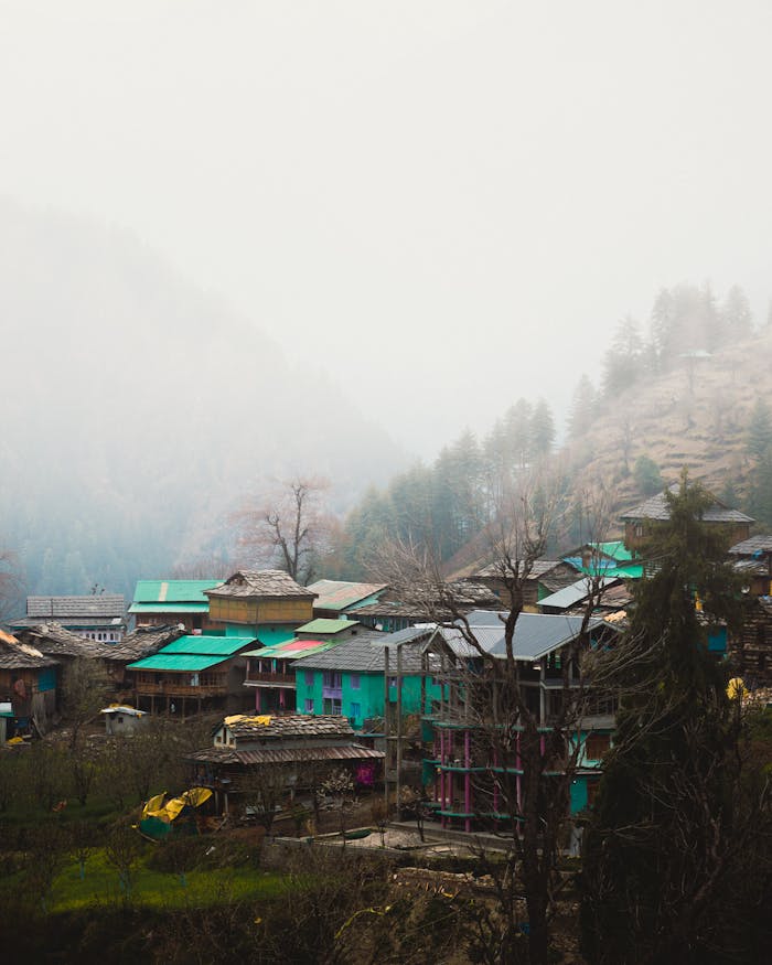 Services Charming rural village in Garahan, HP, India surrounded by mountains and lush greenery.